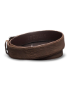 A coiled brown leather belt with textured surface, embossed with the brand name "Tecovas.