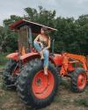 woman wearing the scarf on a tractor