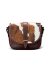 A brown leather handbag with a cowhide patterned flap featuring brown and white spots and a central buckle closure.