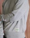 Close up view of the heather gray old school sweatshirt on a man in a photo studio