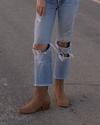 Person wearing jeans wearing the Tecovas Taylor boots.