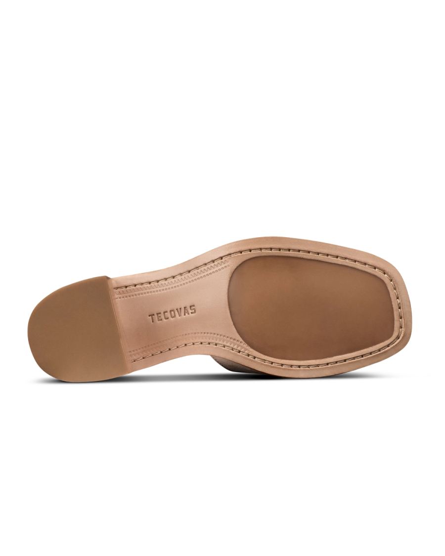 The Carmen Paloma in Pearl Ostrich. The sole of a beige leather shoe with visible stitching, crafted from premium Pearl Ostrich and the brand name "Tecovas" embossed near the arch.