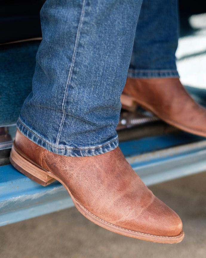 close up picture of Earl scotch brown cowboy boots on a man's feet