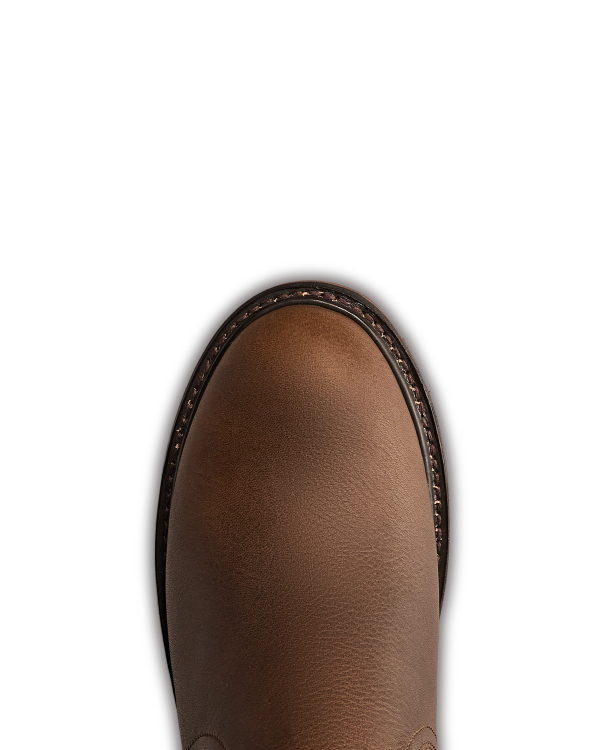 The Chelsea in Cafe Cowhide. Top view of the rounded toe of a brown leather shoe crafted from premium cowhide, with visible stitching around the edge against a plain white background.