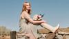 Woman in wedding dress and white cowgirl boots