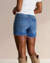 Closeup back view of woman wearing denim cutoff shorts