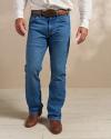 Closeup of man wearing cowboy boots and jeans in a photo studio