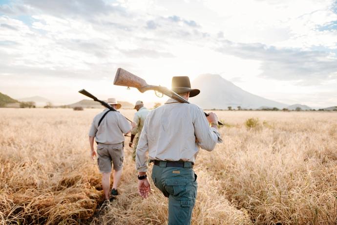 men with guns in a field