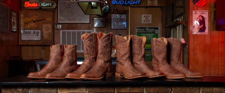 brown, cowboy boots on a table