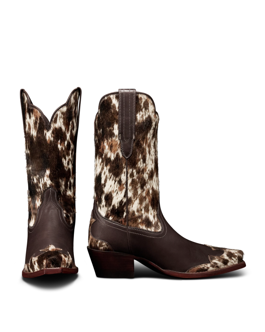 The Sadie in Hair on Hide Hair on Hide / Cowhide. A pair of brown and white Hair on Hide / Cowhide cowboy boots with pointed toes and angled heels, shown from the side and back.