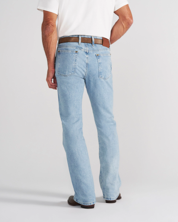 A man seen from behind wearing a white polo shirt, a brown belt, and light-wash blue jeans.