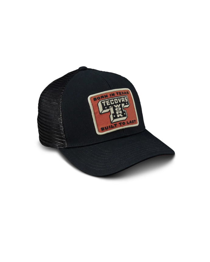 Black mesh trucker hat with a curved brim and a red patch on the front reading "Born in Texas Tecovas Built to Last.