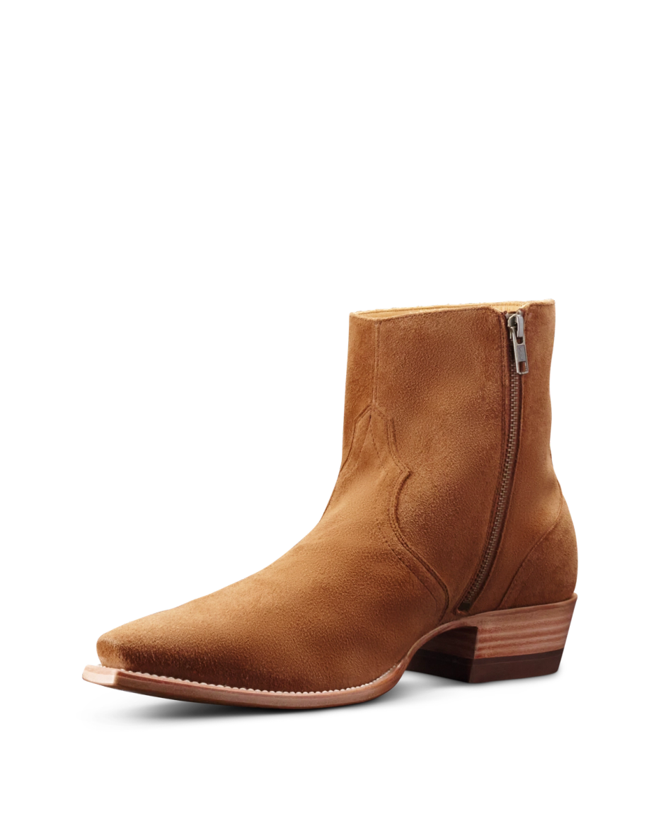 Brown suede ankle boot with a side zipper and stacked heel on a black background.