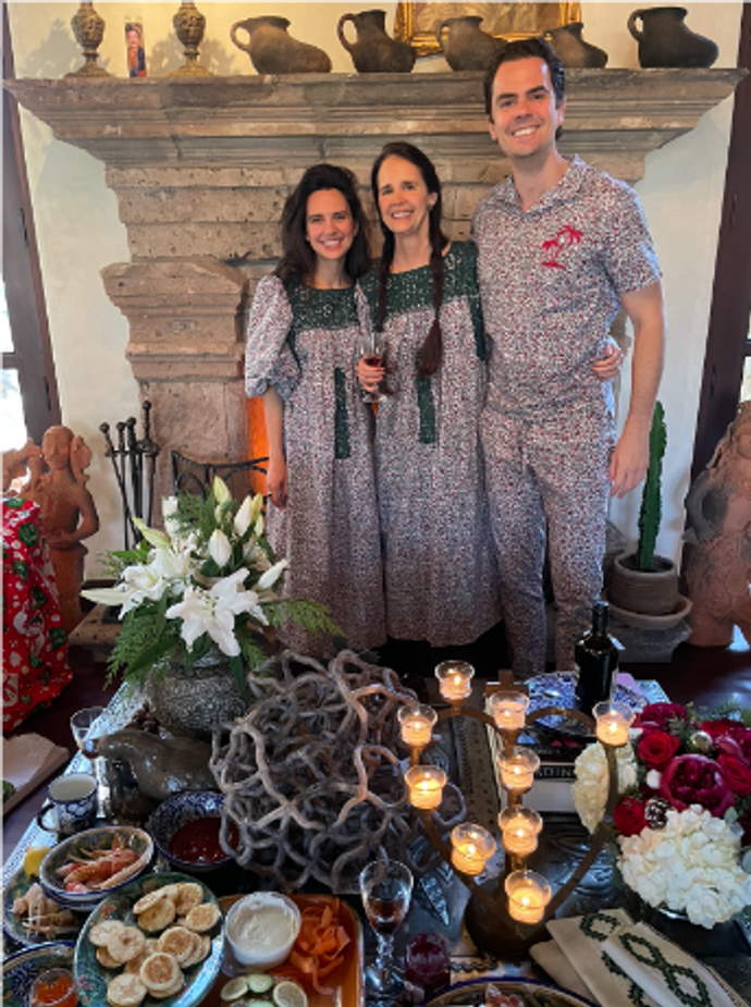 Family standing and hugging in Christmas Pajamas