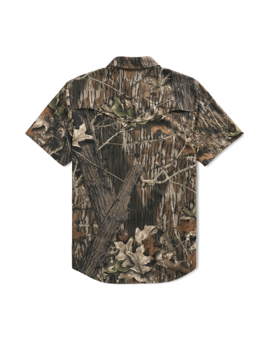 Short-sleeve button-up shirt with a brown, green, and tan camouflage print featuring branches and leaves, shown from the back on a plain white background.