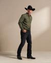 Cowboy wearing The Black Cartwright and jeans with a green button down in a photo studio