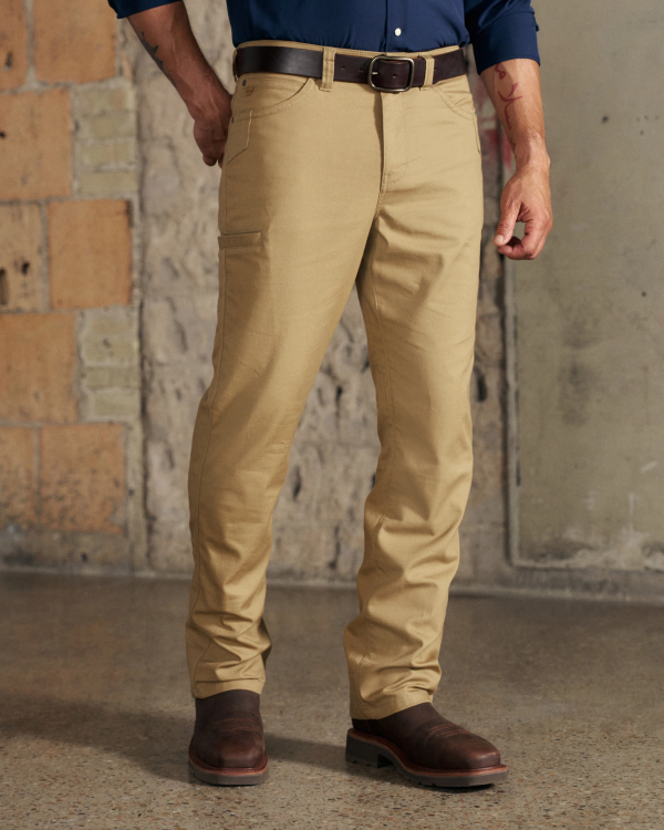 Front view of Men's Work Pant - Desert Tan on model