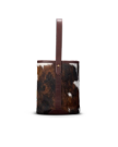 A cylindrical bucket bag with brown and white cowhide exterior, a single brown leather strap, and leather trim, displayed against a plain white background.