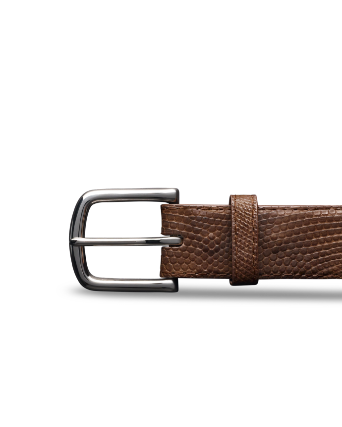 Brown leather belt with a silver buckle on a black background.