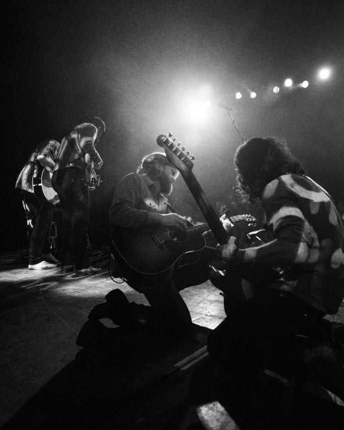 A black and white photo of a group of people on stage.