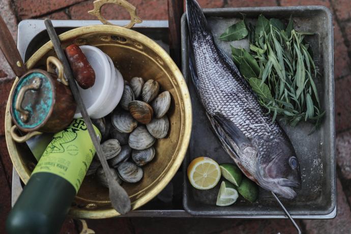 a tray of a fish and utensils for cooking