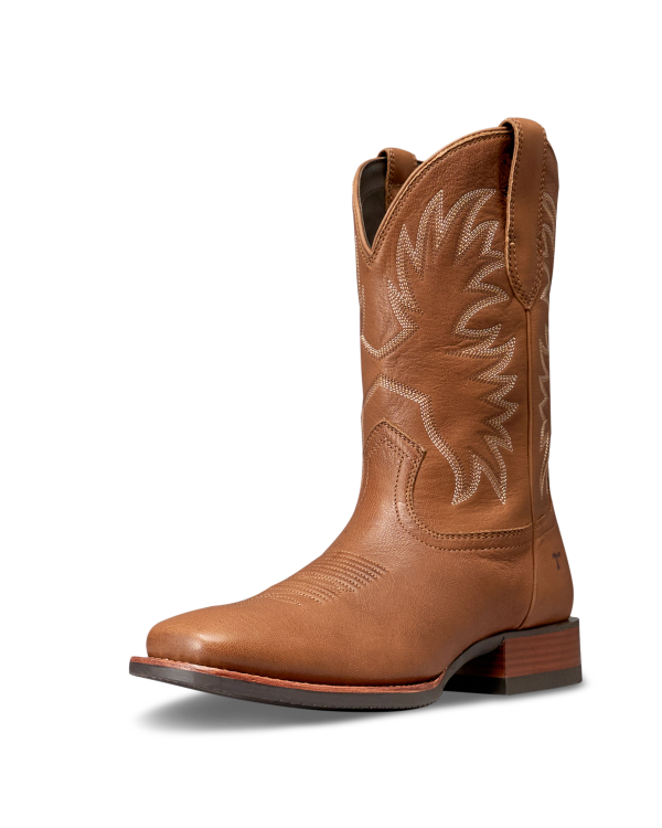 The Dusty in Mesa Goat. A brown leather cowboy boot from The Dusty Goat, featuring white decorative stitching, a low heel, and a pointed toe, shown on a white background.