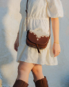 Woman holding a brown tote bag