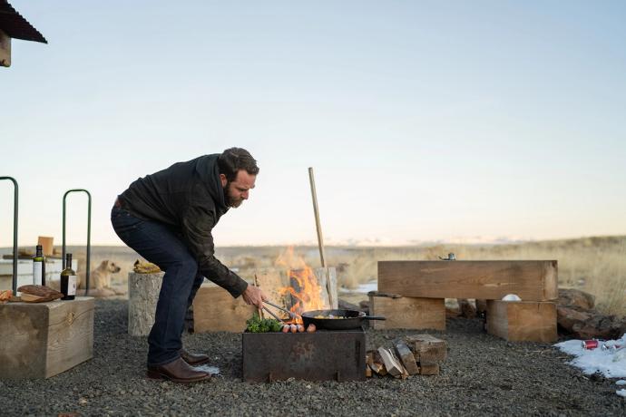 man stoking a fire