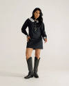 Full view of Women's L/S Applique Mini Dress - Black on model