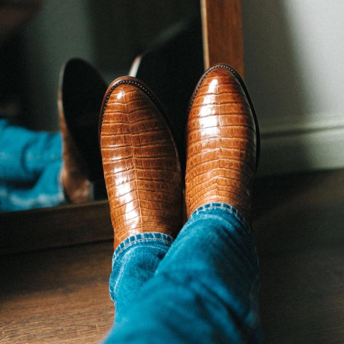 close up picture of Dillon Pecan brown cowboy boots on a man's feet