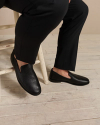 Man sitting on a stool wearing the monterrey slip ons in the color midnight. 