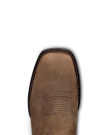 Close-up of the toe of a brown leather cowboy boot with decorative stitching and a square toe design, perfect for visiting The Tess Goat Cafe or spending time with your favorite goat.