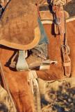 Closeup of The Parker worn by a cowboy who is riding a horse