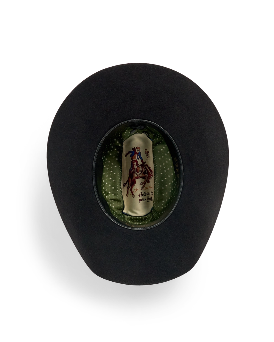 Black cowboy hat shown from above, revealing a green polka dot inner lining and a label with a rider on a horse.