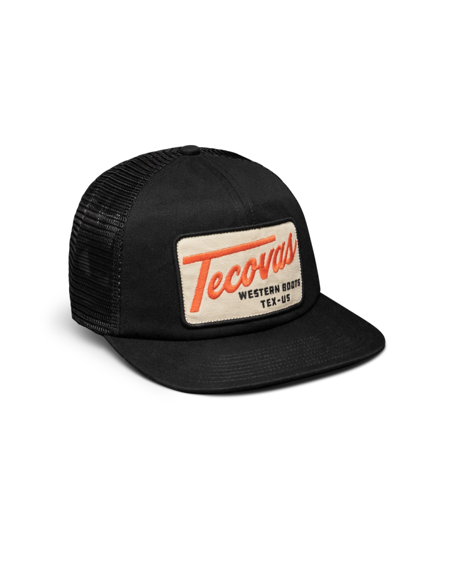Quarterfront view of Tecovas Patch Flat Brim 6 Panel Trucker - Black on plain background