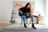woman playing guitar in an apartment