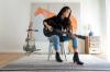 woman playing guitar in an apartment