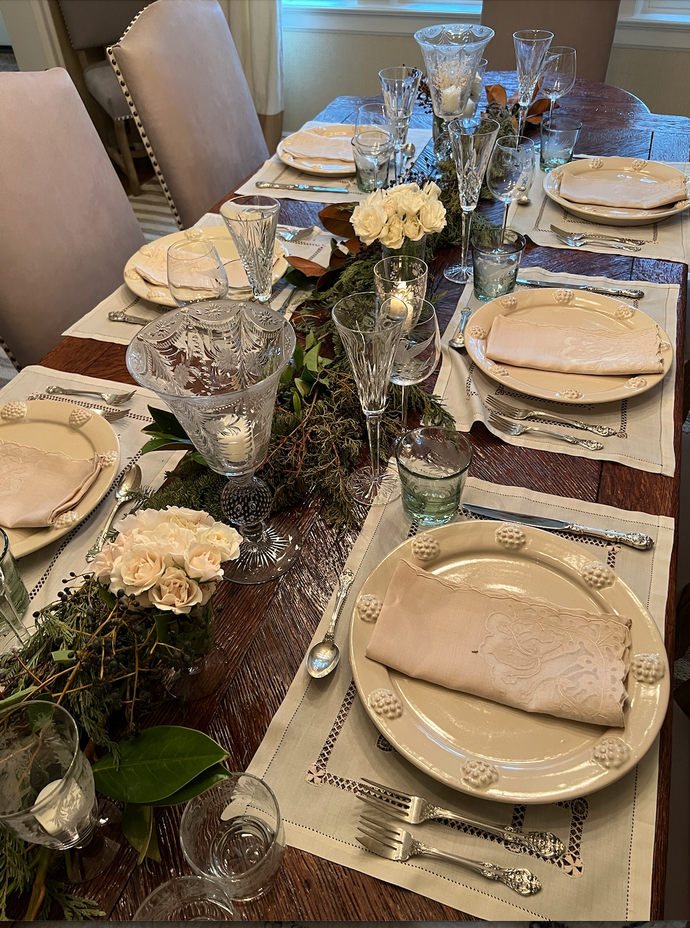 Dining table with plates and floral decorations.