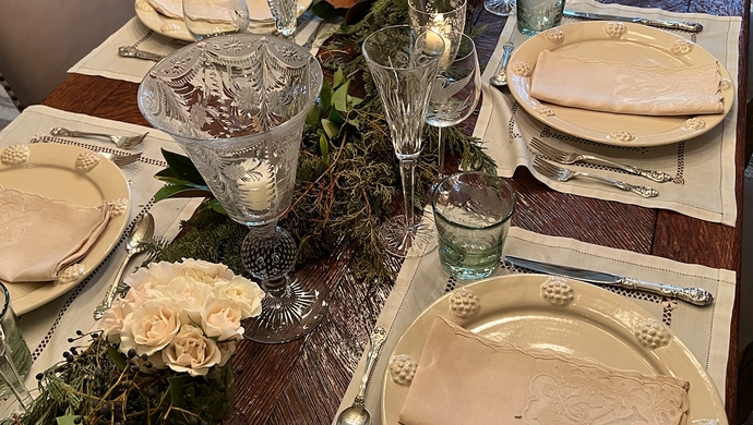 Dining table with plates and floral decorations.