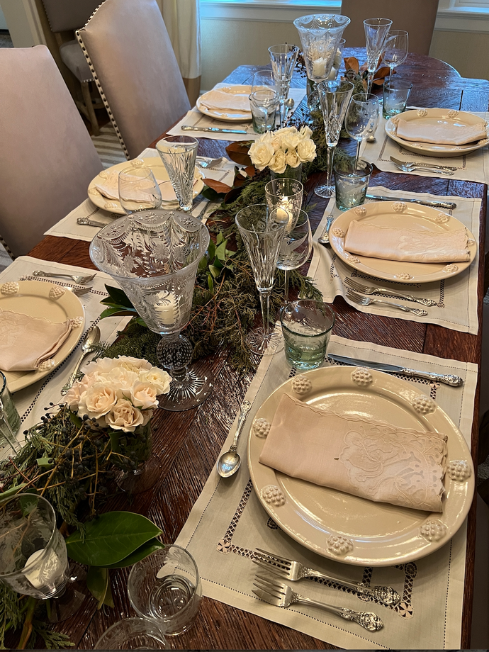 Dining table with plates and floral decorations.