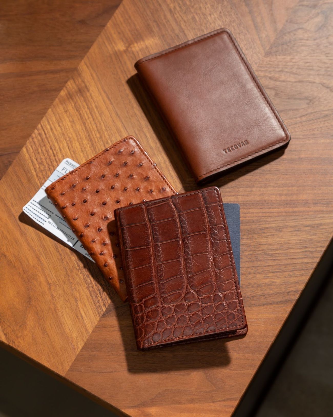 Three Tecovas Wallets sitting on a wood table. 