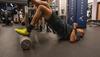 Man lying on ground doing hip thrusts