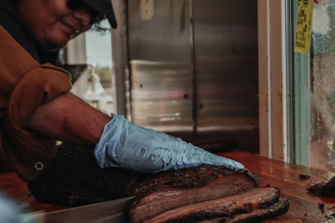 man preparing smoked meat