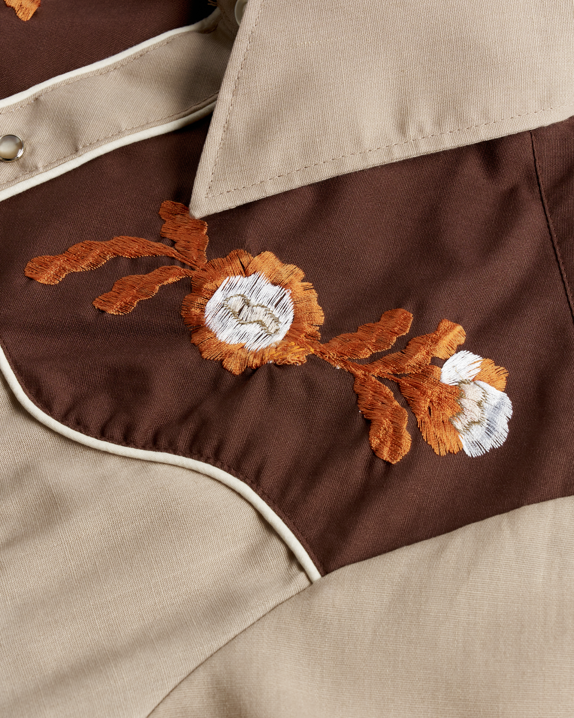 Closeup detail view of Tecovas x Cathy Hahn Men’s Vintage Western Pearl Snap - Tan / Chocolate