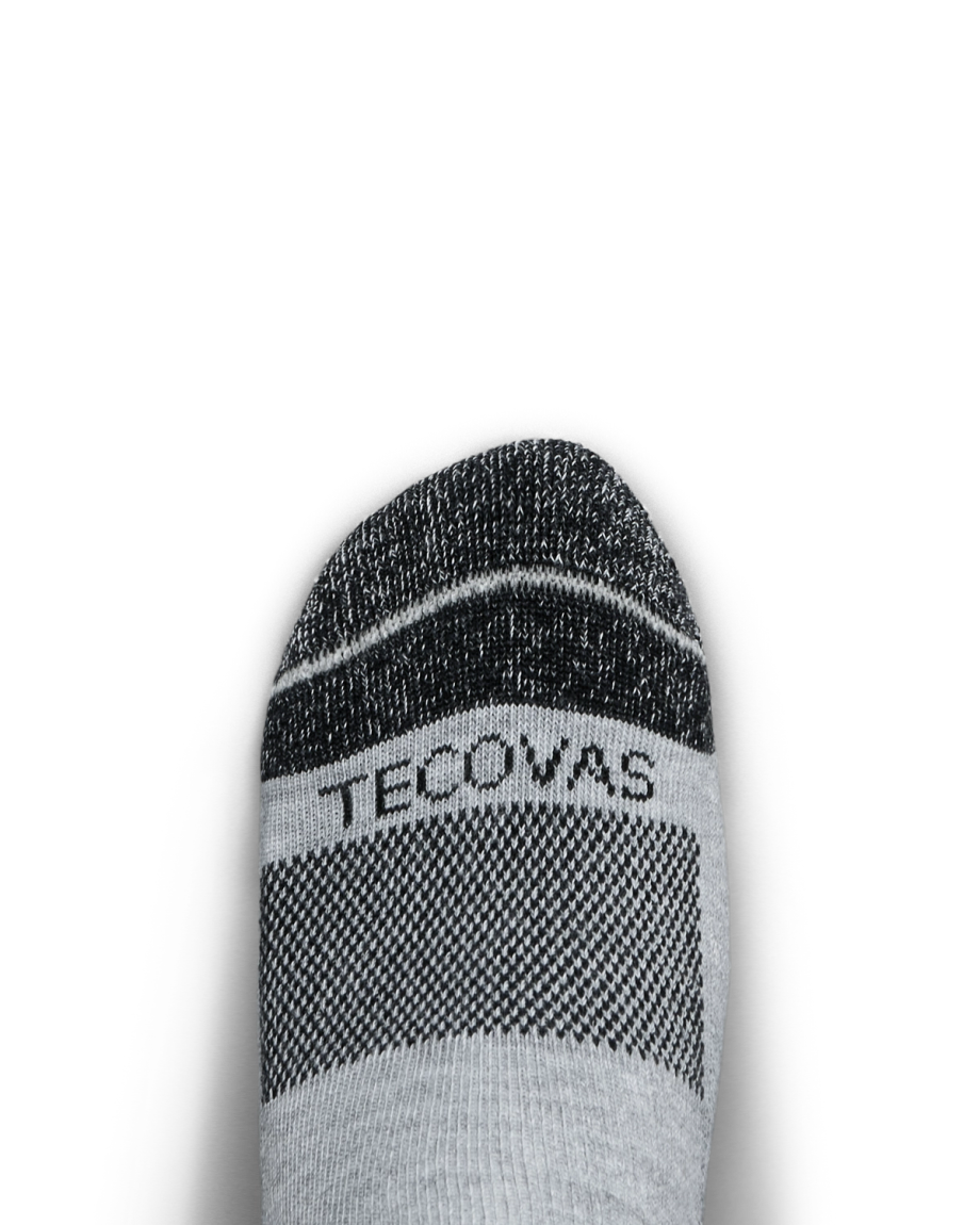 Gray and black sock with the word "Tecovas" on the toe, shown against a plain white background.