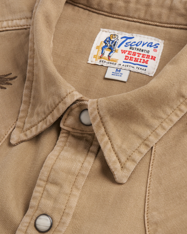 Closeup detail view of Men's Denim Pearl Snap SS - Coriander / Multi