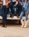 People standing in tecovas boots and leaning against a truck
