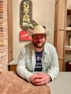 A man in a cowboy hat sitting at a table.