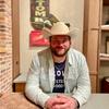 A man in a cowboy hat sitting at a table.