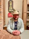 A man in a cowboy hat sitting at a table.